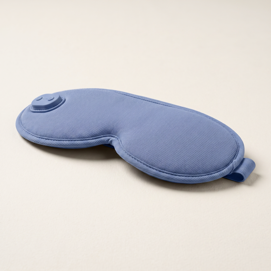 Side profile showing the depth and adjustable strap of the blue eye mask