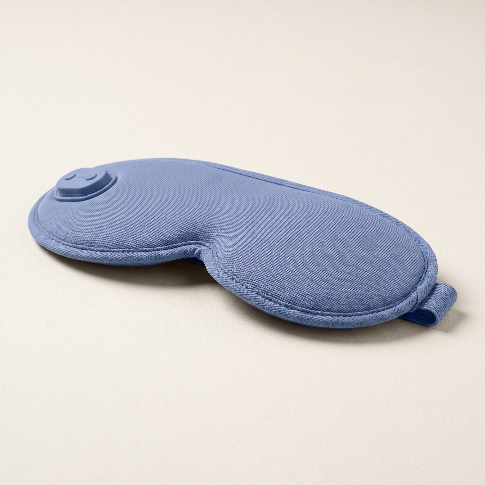 Side profile showing the depth and adjustable strap of the blue eye mask