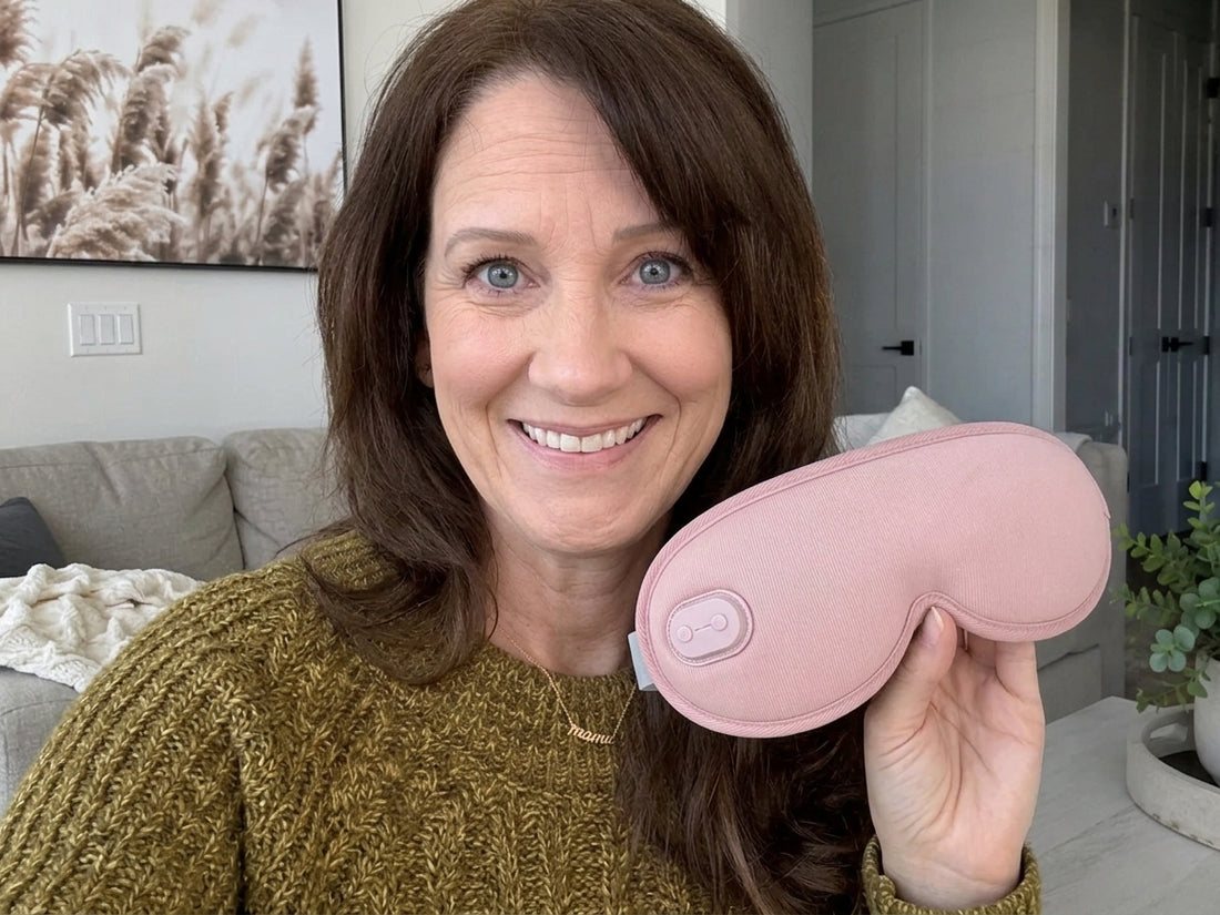 Woman holding the pink heated eye mask in a living room