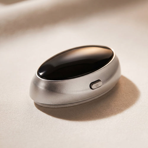 Macro detail of the Quietvana device resting on cream silk